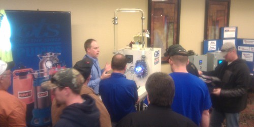 Chris Suomi from Gorman-Rupp demonstrates the glass-faced centrifugal pump at the Snowball Conference in Kearney